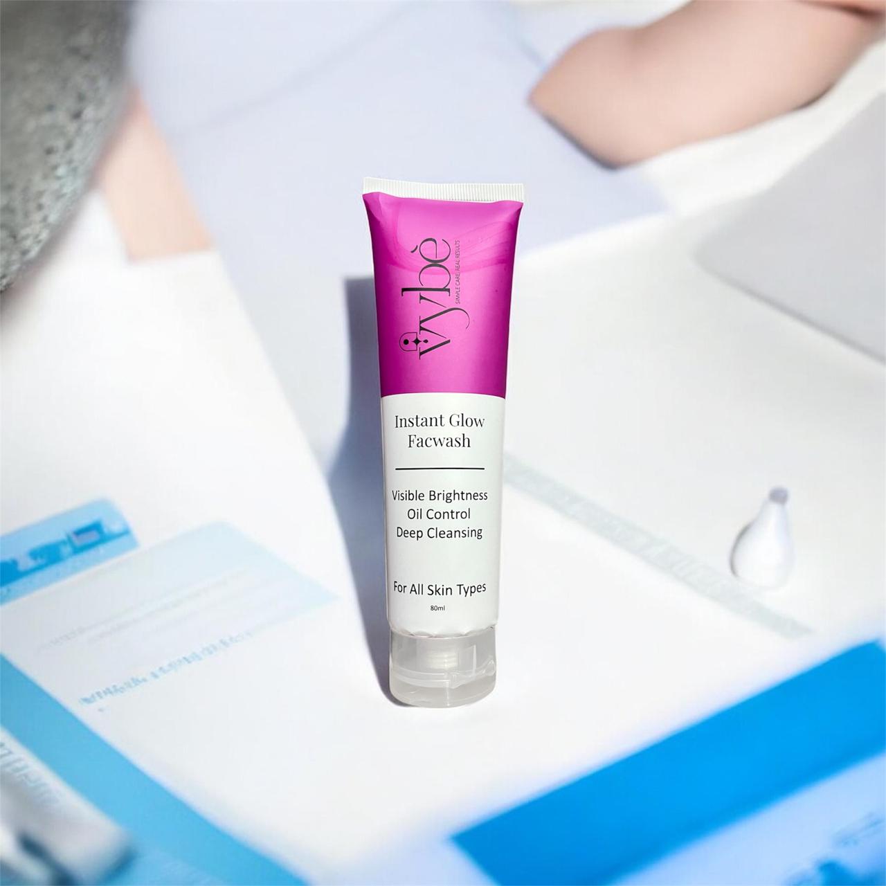 Vybe instant glow Face wash bottle with transparent cap and white label on a blurred background