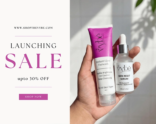 Hand holding vybe skincare products with promotional text for a sale on a white background