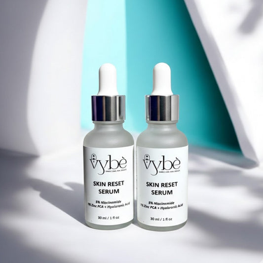 Two bottles of vybe Skin Reset Serum on a light background
